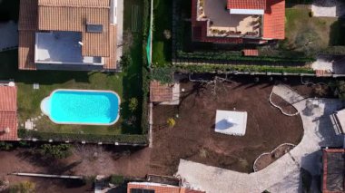 Canlı bir hava perspektifi, kristal berraklığında bir yüzme havuzuyla süslenmiş sakin bir yerleşim alanını ortaya çıkarıyor. Etrafını saran bakımlı bahçeler titiz bir peyzaj sergiliyor..