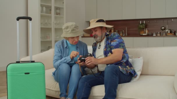 Positive Cheerful Attractive Retired Mature Traveler Couple Sunhats Sitting Sofa — Stock Video