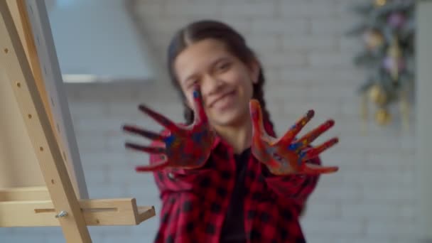 Carefree Smiling Cute Hispanic Teenage Girl Painter Pigtails Showing Hands — Αρχείο Βίντεο