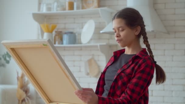 Smiling Cute Talented Hispanic Adolescent Painter Holding Artistic Canvas Looking — Vídeo de Stock