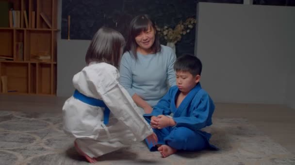 Caring Adorable Preadolescent Asian Martial Arts Girl Uniform Comforting Embracing — Stock Video