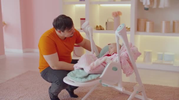 Affectionate Handsome Father Rocking Sleepy Tired Adorable Infant Daughter Cradle — Stock Video