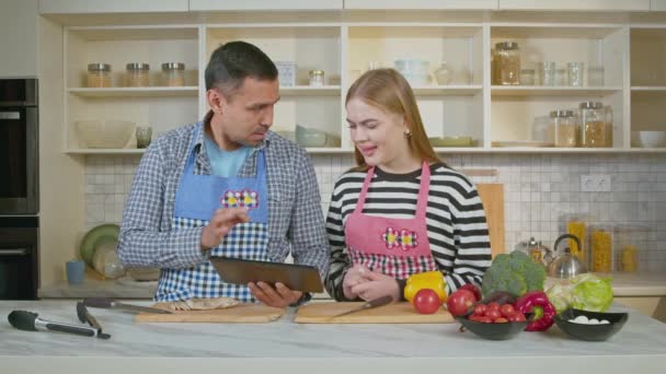 Positive Attractive Hearing Impaired Couple Aprons Networking Digital Tablet Choosing — Stock Video