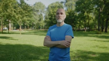 Kendine güvenen çekici atletik formda, kolları çapraz duran, doğada çalışırken azim, motivasyon ve arkadaşlığı ifade eden olgun bir adamın hayat tarzı portresi..