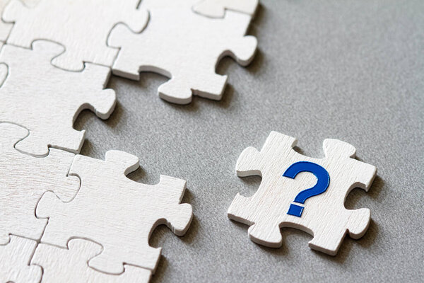 Puzzle piece with question mark, missing piece, business concept