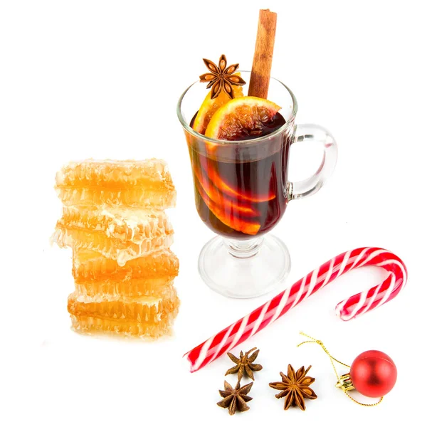 Mulled wine, honeycomb and spices isolated on white background.