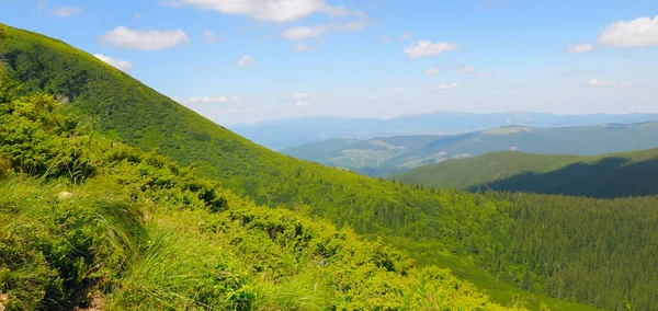 Bright mountain landscape with mountain peaks and sky. Carpathians. Ukraine. Wide photo.