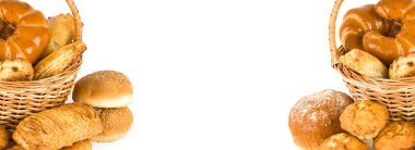 Sweet pastries in a basket isolated on a white background. Free space for text. Wide photo.