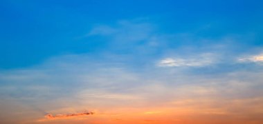 Bright sunrise against the blue sky. Wide photo.