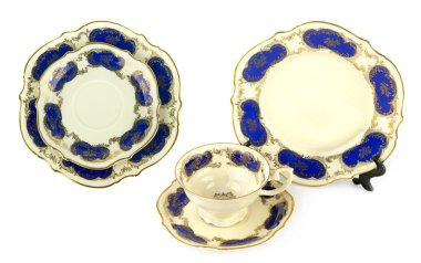 Beyaz arka planda izole edilmiş klasik porselen bardak, tabak ve çay tabağı. Kolaj.