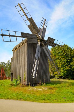 Old windmill in the Museum of National Architecture in Pirogovo, Kyiv, Ukraine. Vertical photo. clipart