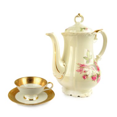 Zarif klasik porselen kahve demliği, porselen bardak ve beyaz arka planda izole edilmiş çay tabakları. Metin için boş alan.