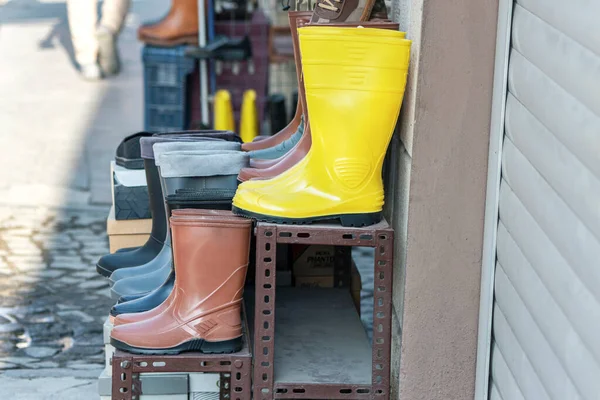 Waterproof rain boots on an outdoor market stall, close up