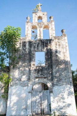 Yaxunah, Yucatan, Meksika 'daki ağır yıpranmış Katolik kilisesinin önünde.