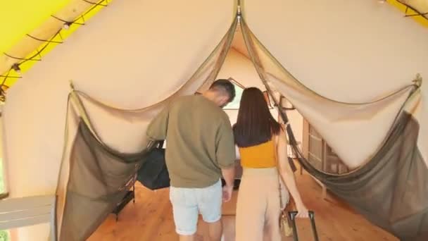 Tracking Young Biracial Woman Man Carrying Luggage Arriving Tent Glamping — 비디오