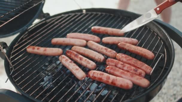 Close Cropped Guy Roasting Sausages Grill Flipping Them Knife Outdoors — Stok Video
