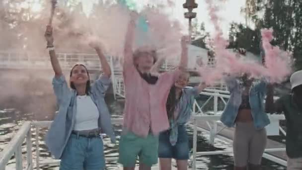 Medium Long Diverse Young People Standing Colorful Smoke Bombs Pier — Stockvideo
