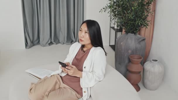 High Angle Female Asian Smm Manager Sitting White Designer Couch — 图库视频影像