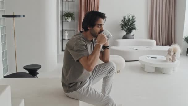 Medium Long Middle Eastern Young Man Sitting White Stairs House — Vídeo de stock