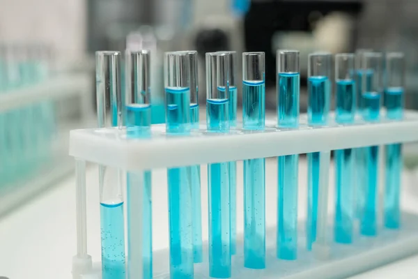 Row Several Flasks Test Tubes Blue Liquid Workplace Modern Healthcare — Foto de Stock