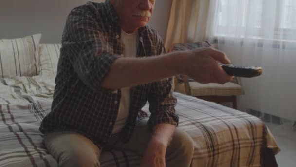 Tilting Bored Senior Caucasian Man Sitting Bed Home Evening Switching — Stockvideo