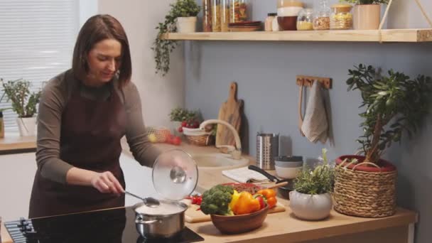 Tracking Shot Woman Apron Stirring Pasta Pot Boiling Water While — Vídeo de stock