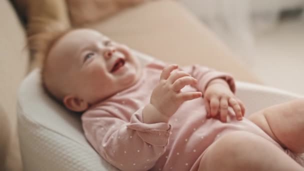 Medium Long Adorable Blue Eyed Biracial Infant Pink Onesie Lying — Video Stock