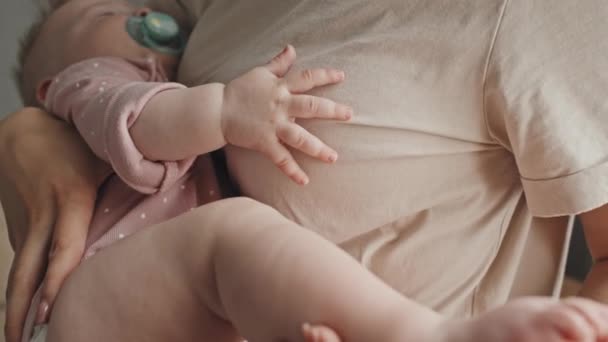 Tilting Cropped Mother Holding Feet Rocking Sleeping Infant Home Daytime — ストック動画