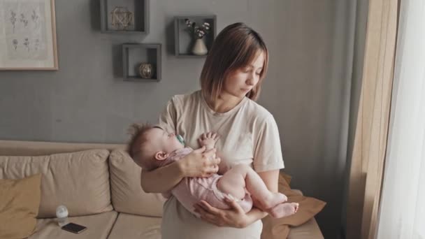 Medium Young Biracial Woman Holding Sleeping Baby Daughter Pacifier Standing — Vídeos de Stock