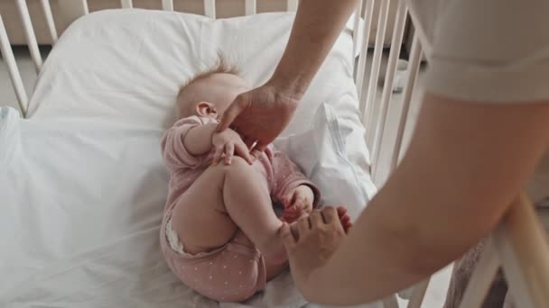 Top Unrecognizable Parent Putting Sleeping Baby Girl Pacifier Crib Home — Vídeos de Stock