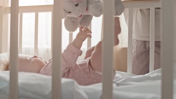 Side View Joyful Biracial Newborn Girl Pink Clothes Lying Crib — Vídeo de stock