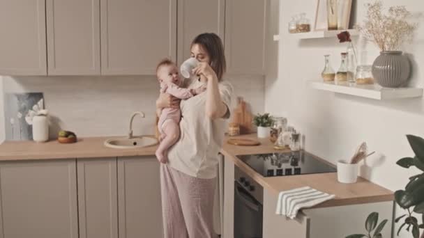 Medium Long Young Biracial Woman Loungewear Holding Cute Baby Girl — Stockvideo