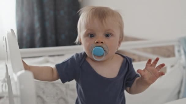 Waist Blond Haired Caucasian Toddler Pacifier Mouth Standing Crib Daytime — Vídeos de Stock