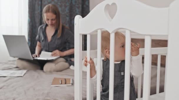 Medium Adorable Blue Eyed Toddler Boy Sucking Pacifier Standing Crib — Stock Video