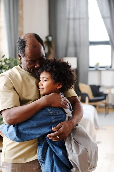 Senior Black Man Embracing His Cute Grandson Backpack Living Room — Stockfoto
