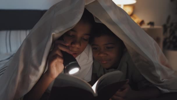 Medium Close Cheerful Black Girl Boy Lying Stomachs Blanket Bed — Stock Video