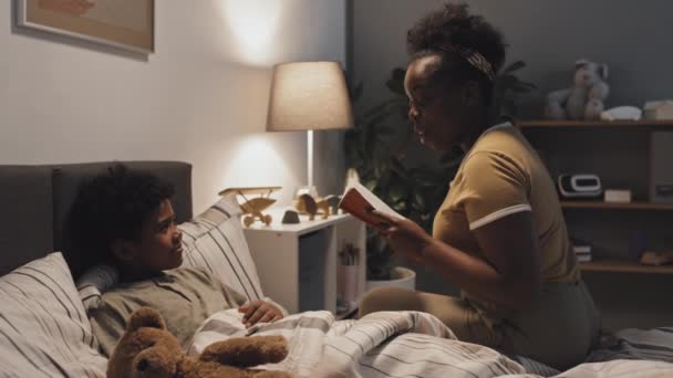 Medium Long Side View Young Black Woman Sitting Edge Bed — Vídeos de Stock
