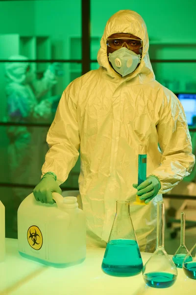 Modern Scientist Coveralls Holding Canister Flask Blue Liquid Substance While — Foto de Stock