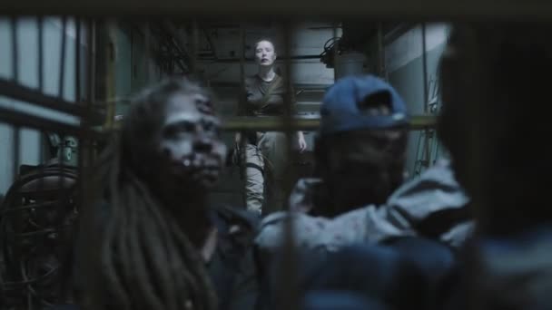 Military Woman Shaved Head Moving Away Zombies Cage Wheels Dark — Video Stock