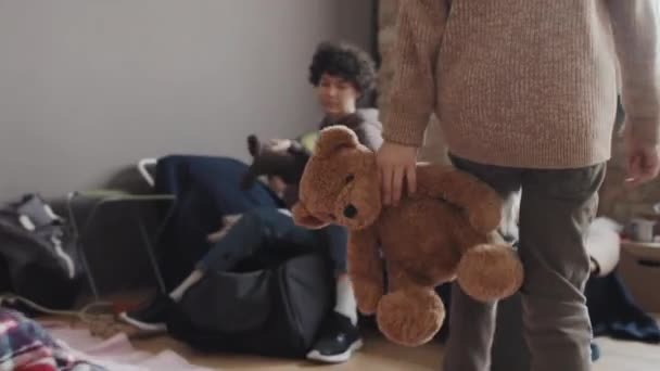 Tracking Low Angle Cute Caucasian Little Boy Carrying Stuffed Bear — Stok video