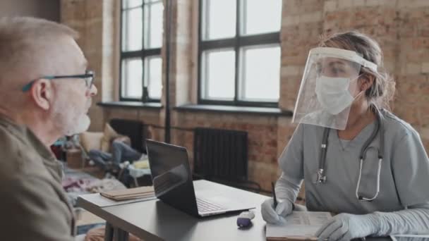 Waist Female Biracial Medical Worker Scrub Suit Face Shield Sitting — Vídeos de Stock