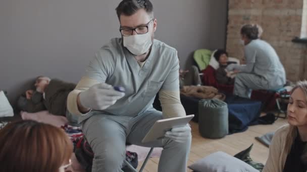 Medium Long Male Caucasian Nurse Scrub Suit Face Mask Checking — Stockvideo