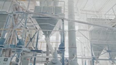 No people wide shot of industrial machinery and equipment in modern white marble factory