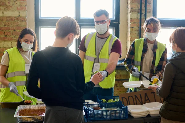 Three Volunteers Protective Masks Passing Food Refugees Temporarily Homeless People — Stock Photo, Image