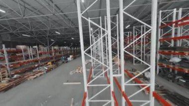 Drone tracking view of shelves in storage in afternoon