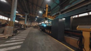 Drone arc view of robotic welding equipment at factory