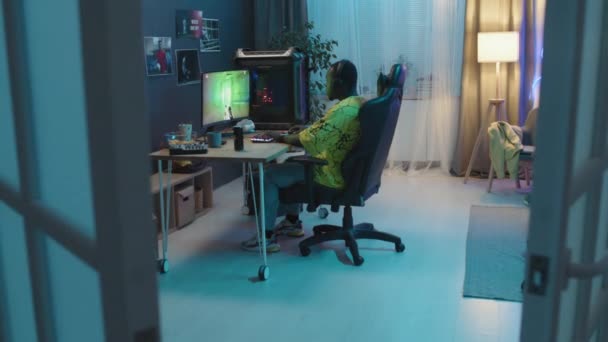 Full Shot Black Teenage Male Gamer Sitting Computer His Room — Vídeo de stock