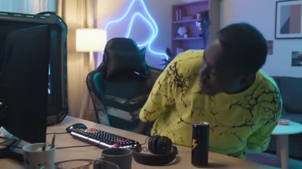 Medium Shot Teenage African American Guy Sitting Chair Front Gaming — стоковое видео