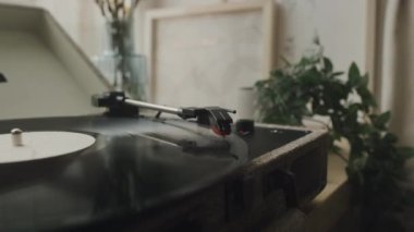 No people closeup of retro style vinyl record player on windowsill playing song