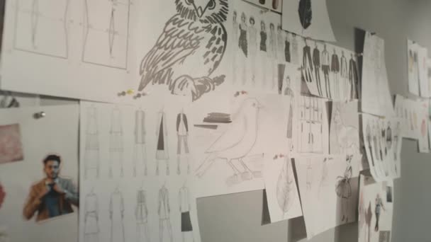 People Shot Many Clothes Sketches Inspiration Ideas Hanging Grey Wall — Vídeo de Stock